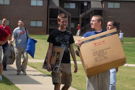 Jordan Hayes, freshman, and his brother Jacob move into the Heritage Complex on freshman move-in day.

 - Photo by Kristi McMurry Woody