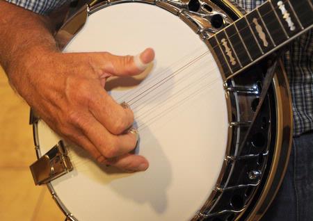 George Brint plays the banjo before the Faculty/Staff Dinner. - Photo by Morris Abernathy