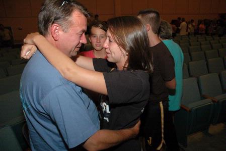After a long day of moving onto campus, Tabitah Shera says goodbye to her father Phil as her sister Becca looks on, after the new student worship service during orientation. - Photo by Beth Spain