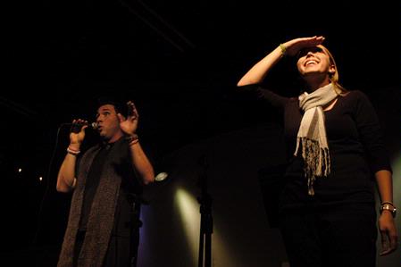 Scott McSwain and Jill Brown emcee the Focus Open Mic night and open with a rendition of <em>The Star Spangled Banner</em>. - Photo by Sarah Palmer Goff