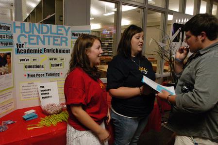 Libby Ford, senior accounting major, and Abby McBroom, senior nursing major, speak to Freshman Andy McBroom about the Hundley Center for Academic Enrichment at the organization fair. - Photo by Sarah Palmer Goff
