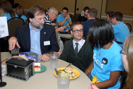 Hal Poe, Colson professor of faith & culture, and Greg Thornbury, dean of the school of Christian studies, talk to an incoming freshman about the Christian Studies department during new student orientation. - Photo by Kristi McMurry Woody