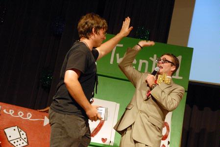 Zach Preston, freshman, high-fives the host of the SAC Game Show after winning an iPod nano. - Photo by Kristi McMurry Woody