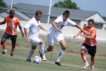 Rafael Carvalho, sophomore business administration major, and Kemal Gogic, freshman, keep the ball away from their Brewton Parker opponents. - Photo by Kristi McMurry Woody