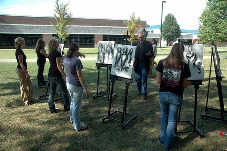 Chris Nadaskay, professor of art, teaches his Drawing I class outside in the grove. - Photo by Beth Spain