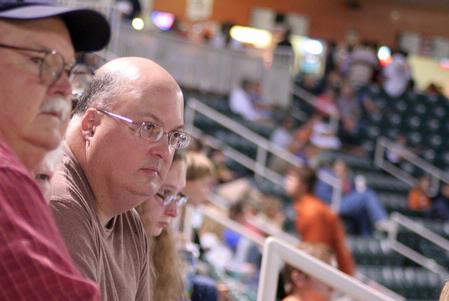 Bryan Dawson, professor of mathematics, enjoys a Diamond Jaxx baseball game on college night at Pringles Park. - Photo by Kristi McMurry Woody