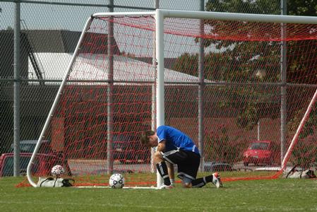 J. Landham, sophomore, kneels in prayer before the men's soccer game against Reinhardt College. - Photo by Sarah Palmer Goff
