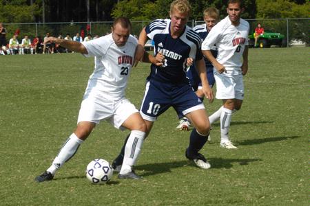 Dejan Kostic holds off a Reinhardt defender in a match on Sept. 12 - Photo by Sarah Palmer Goff