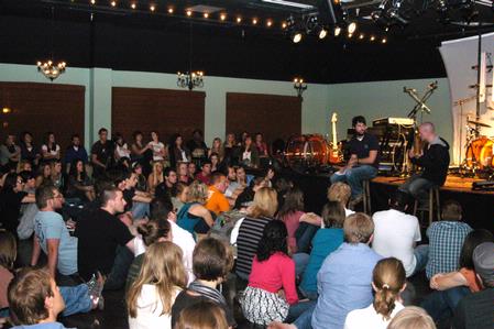 Students listen as Stephen Capps, junior Biblical languages major, interviews Derek Webb before the concert at Barefoots Joe. - Photo by Sarah Palmer Goff