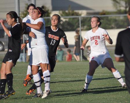 Bridget Rooney and Sara Weir (2) battle for ball possession. - Photo by Tommy Sadler