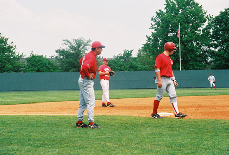 Josh Allen, Union's first baseman from Jackson takes a lead during in the alumni vs. current players game.  Union's head coach Andy Rushing and 2002 alumnas Jeff Wyatt (third base) look on. - Photo by Steven Aldridge