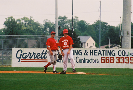 Union first baseman Josh Allen of Jackson and 2000 alumnas John Melton have a laugh as the current Bulldogs battle the alumni. - Photo by Steven Aldridge