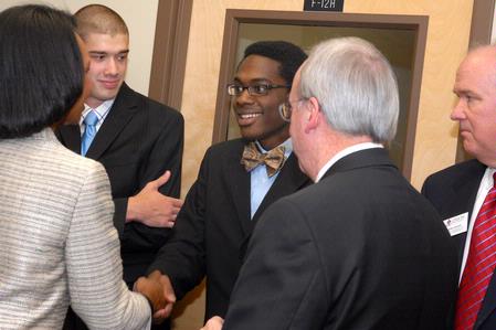 Shawn Okpebholo, assistant professor of music, shakes hands with former Secretary of State Condoleezza Rice during a reception before the 2009 Scholarship Banquet. - Photo by Kristi McMurry Woody