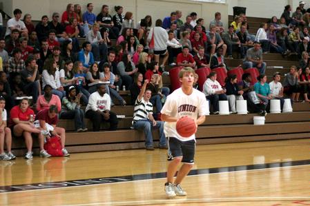 Brett Barry, freshman member of the Union men's golf team, prepares to shoot a three point shot for a competition during Bulldog Madness, an annual event that gets students and community members pumped for the upcoming basketball season. - Photo by Kristi McMurry Woody
