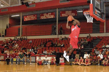 Samuel Danache,  sophomore, does a slam dunk for the judged dunking contest during Bulldog Madness. - Photo by Kristi McMurry Woody