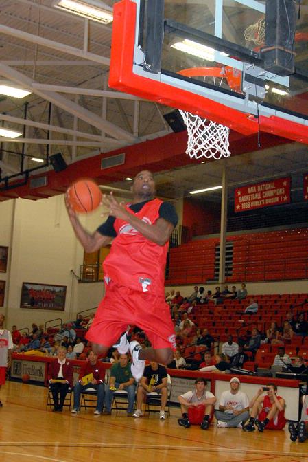 Samuel Danache,  sophomore, does a slam dunk for the judged dunking contest during Bulldog Madness. - Photo by Kristi McMurry Woody