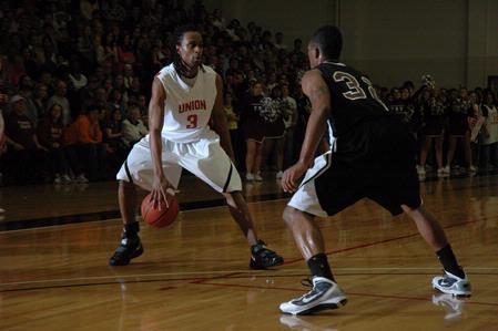 Senior Tacuma Alexander dribbles around a Freed Hardeman University player during the TranSouth Tournament championship game in which the Bulldogs won 75-65 - Photo by Jordan Buie