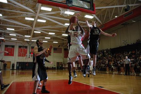Senior Greg Truvillion goes up for a shot against Freed Hardeman University players during the TranSouth Tournament championship game. The Bulldogs came out as champions with a score of 75-65.  - Photo by Jordan Buie