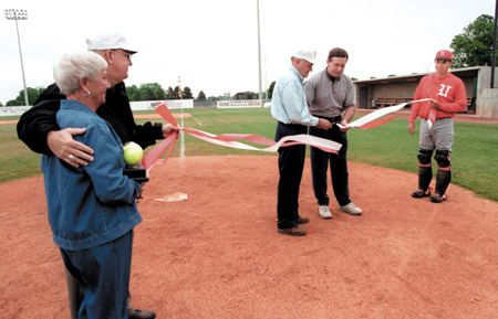 Norma Fesmire, Coach David Blackstock, and Coach Andy Rushing hold the ribbon as Benny Fesmire and Union Board of Trustee Chairman Jack Holmes cut the ribbon during the dedication service for Fesmire Fields. - Photo by Jim Veneman