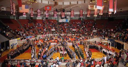 NAIA staff members spell out "NAIA" on the basketball court for the opening ceremonies of the Women's Basketball Tournament.  - Photo by Morris Abernathy