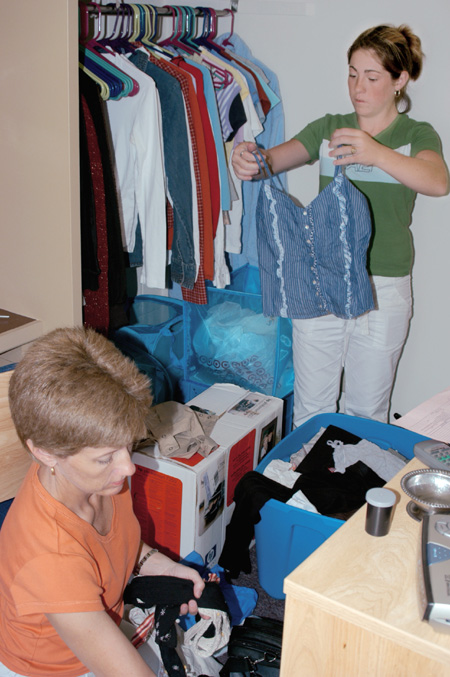 Kate Runyon of Evansville, Ind. and her mother unpack clothes while moving into her new dorm room at Union during FOCUS 2003. - Photo by Lindsay Stavish