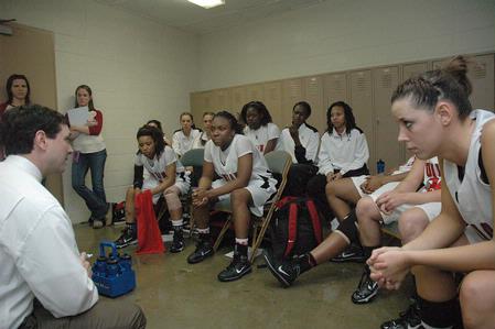 The Lady Bulldogs talk with Mark Campbell, head coach, about strategies during halftime of the Championship game of the NAIA National Tournament.  - Photo by Jordan Buie