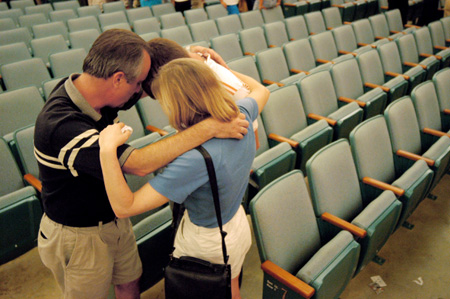 After the FOCUS 2003 worship service on Saturday night, the Michael family of Louisville, Ky. prays and says goodbye to their son Robert. - Photo by Justin Veneman
