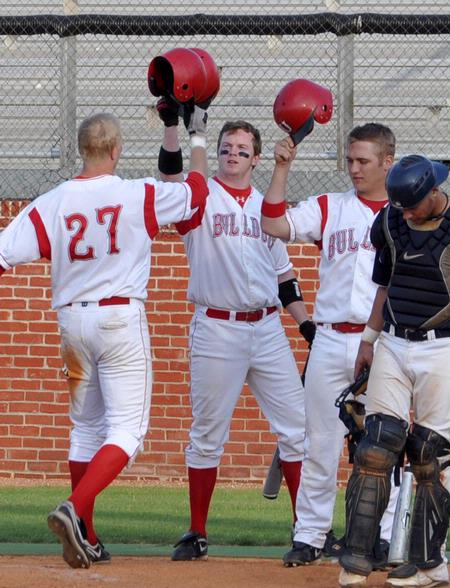 Corey Rudolph (27), Grant Luke (middle) and Beau Baker (right) celebrate a Rudolph home run. - Photo by Steven Aldridge