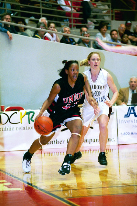 Union senior forward, Tashekia Brown (23) drive the baseline in the 2003 NAIA National Tournament. - Photo by Justin Veneman