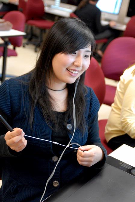 Shinae Giffin, sophomore art major, works on a poster in the digital media studies lab. - Photo by Kristi McMurry Woody