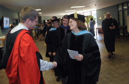 Teresa West, professor of psychology and department chair congratulates Dr. Ray Van Neste after the he received the Faculty of the Year award. - Photo by Morris Abernathy