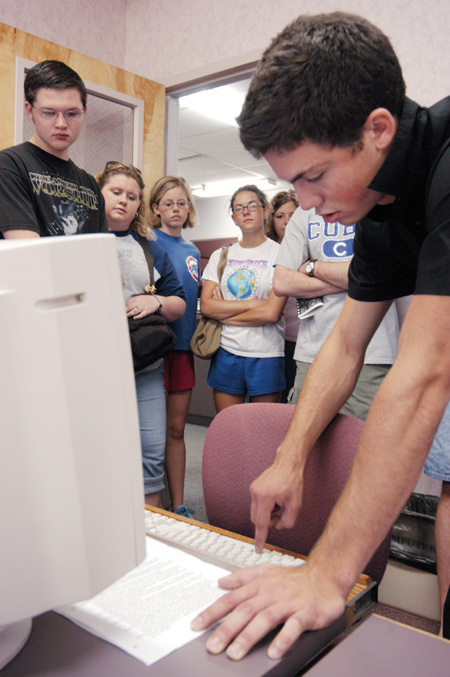 John Reed explains to his FOCUS group how to login to the campus network in the computer center. - Photo by Justin Veneman