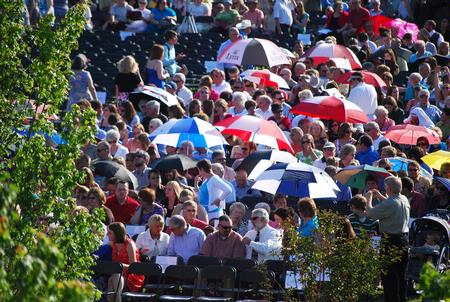 Friends and family of 2010 graduates used umbrellas to shield themselves from the intense sun at the commencement ceremonies.  - Photo by Abigail Harris