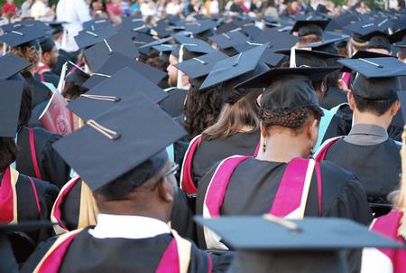 Graduates bow in prayer and thanksgiving at the spring 2010 commencement ceremony. - Photo by Abigail Harris