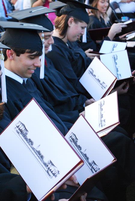 Graduating seniors check out their diplomas after receiving them at the spring 2010 commencement ceremony. - Photo by Abigail Harris