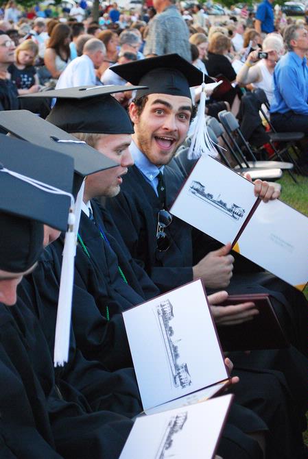 Hilmar Jonathan Skagfield, graduating philosophy major, excitedly displays the cover where his diploma will go will he completes his July classes.  - Photo by Abigail Harris