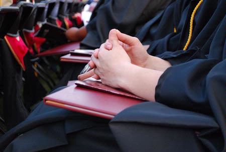 Graduates make time for prayer and thanksgiving at the close of the spring 2010 commencement ceremony. - Photo by Abigail Harris