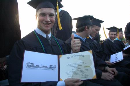 Mathematics graduate, Peter Boedeker, proudly displays his diploma after receiving it during the Spring 2010 commencement ceremony.  - Photo by Beth Spain