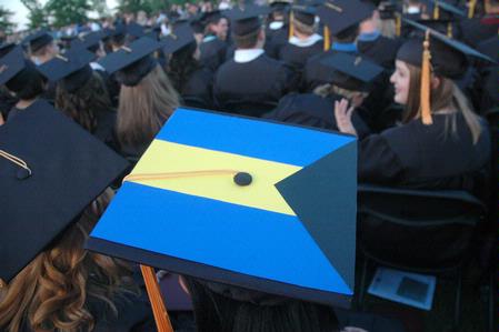 A few students decoratively represent national flags on their graduation caps at the spring 2010 graduation ceremony. - Photo by Beth Spain