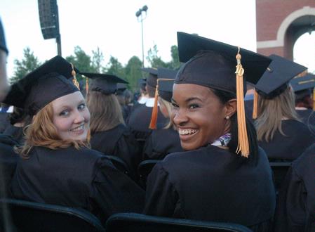 Nursing graduates Elizabeth Matlock and Raquel Mack share excitement with friends at the spring 2010 commencement ceremony. 
 - Photo by Beth Spain