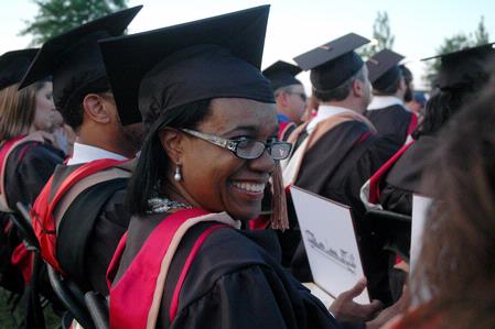 Elizabeth Johnson happily looks back at friends and family after receiving her master of business administration at the spring 2010 graduation ceremony.  - Photo by Beth Spain