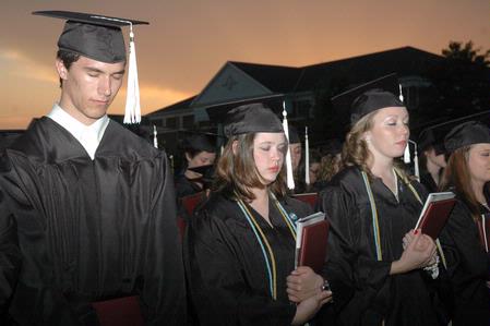 Graduates in the class of 2010 pray as they conclude the spring commencement ceremony. - Photo by Beth Spain