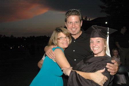 Natalie West, public relations graduate, celebrates with her family after the Spring 2010 graduation ceremony. - Photo by Beth Spain