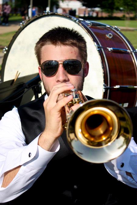 Chase Techentin, sophomore music major, plays trumpet during the 2010 Spring Commencement Ceremony. - Photo by Ebbie Davis