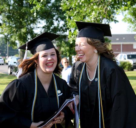 Graduating seniors Margaret Broersma, theatre/speech major, and Jill Brown, French major, laugh in the line before the spring 2010 graduation ceremony. 
 - Photo by Ebbie Davis