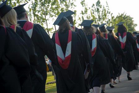 Students receiving their Masters degrees walk in the processional to the 2010 graduation ceremony.  - Photo by Morris Abernathy