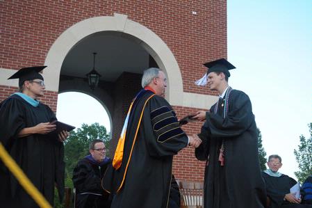 Noah Arnold receives his diploma from Dr. David S. Dockery at the spring 2010 commencement ceremony.  - Photo by Morris Abernathy