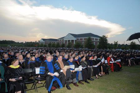 Faculty members watch as graduating seniors receive their diplomas at the spring 2010 commencement ceremony.  - Photo by Morris Abernathy