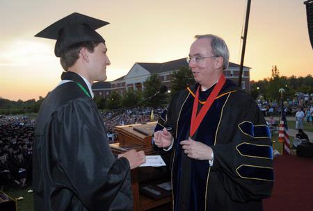 Dr. David S. Dockery, president of Union University, presents graduating broadcast journalism major, Matthew Kuchem, with the Tigrett Medal at the spring 2010 commencement ceremony.  - Photo by Morris Abernathy