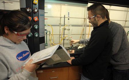 Students conduct a chemistry experiment in lab. - Photo by Morris Abernathy